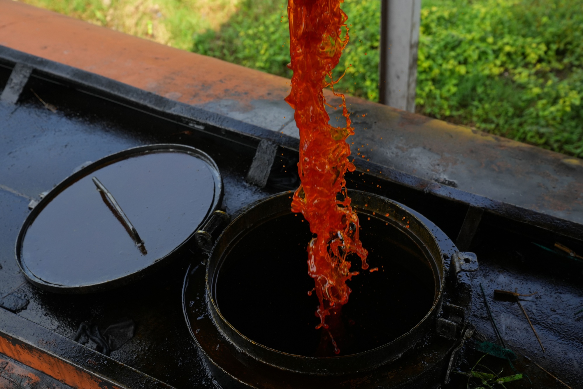 A truck receives crude palm oil from a tank&nbsp;at a palm oil processing factory in West Java, Indonesia.