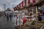 Customers purchase snacks from a mobile stall on Eminonu Square in Istanbul, Turkey,.
