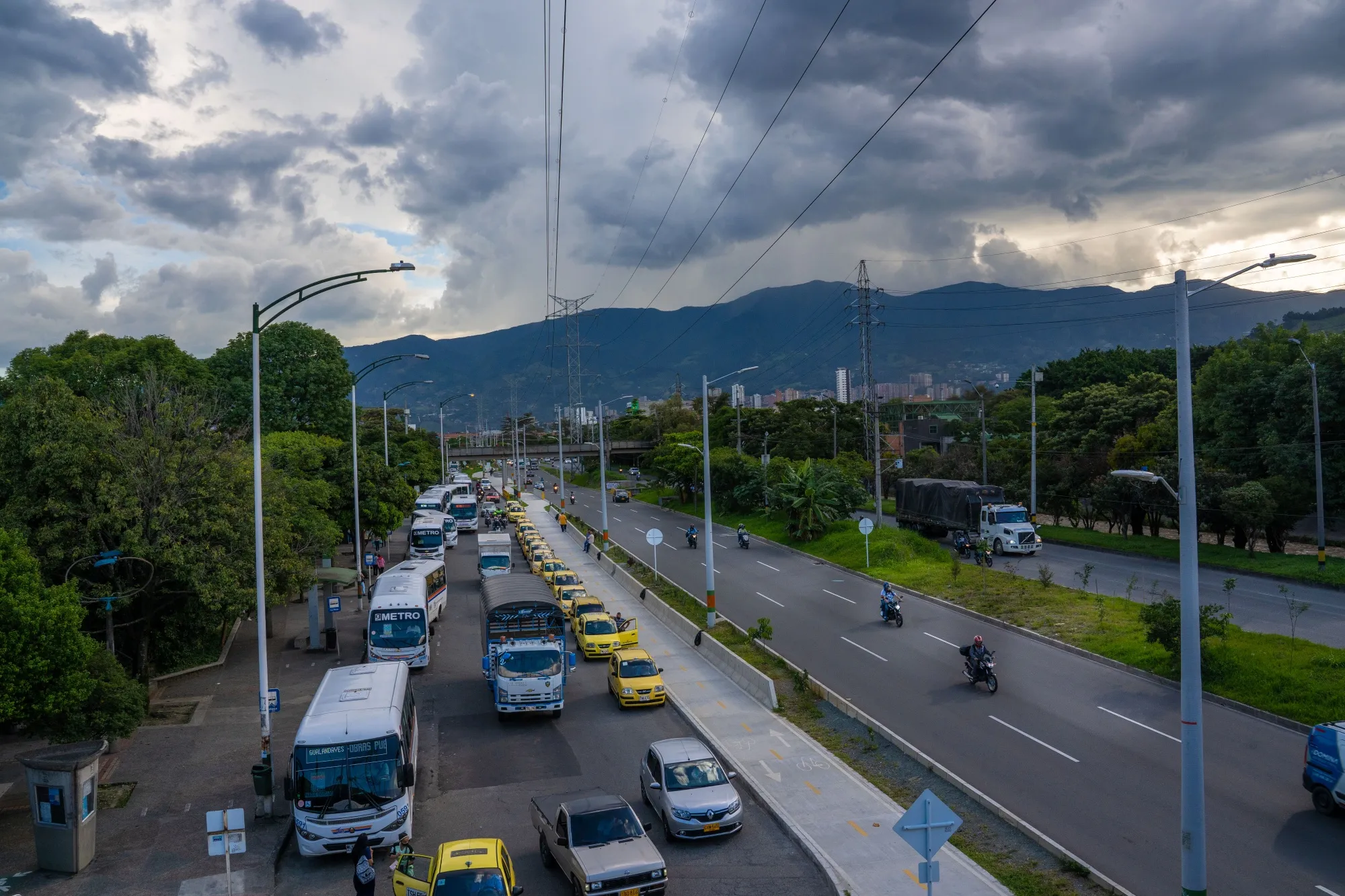 Taxis and buses wait on a highway in Medellin, Colombia.&nbsp;