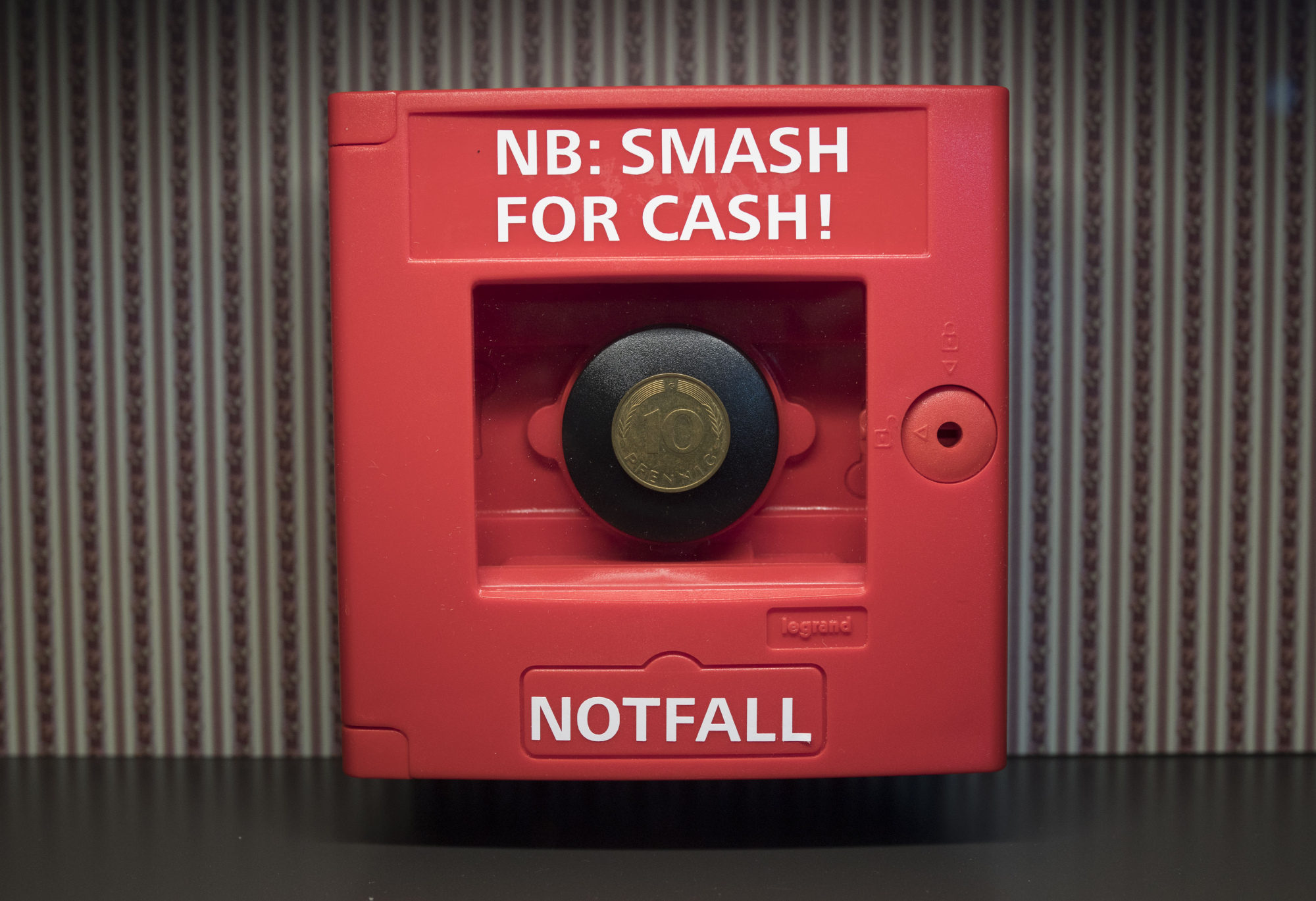 An historic ten pfennig coin sits inside an emergency box reading &quot;Smash for Cash&quot; at the Deutsche Bundesbank's money museum in Frankfurt.