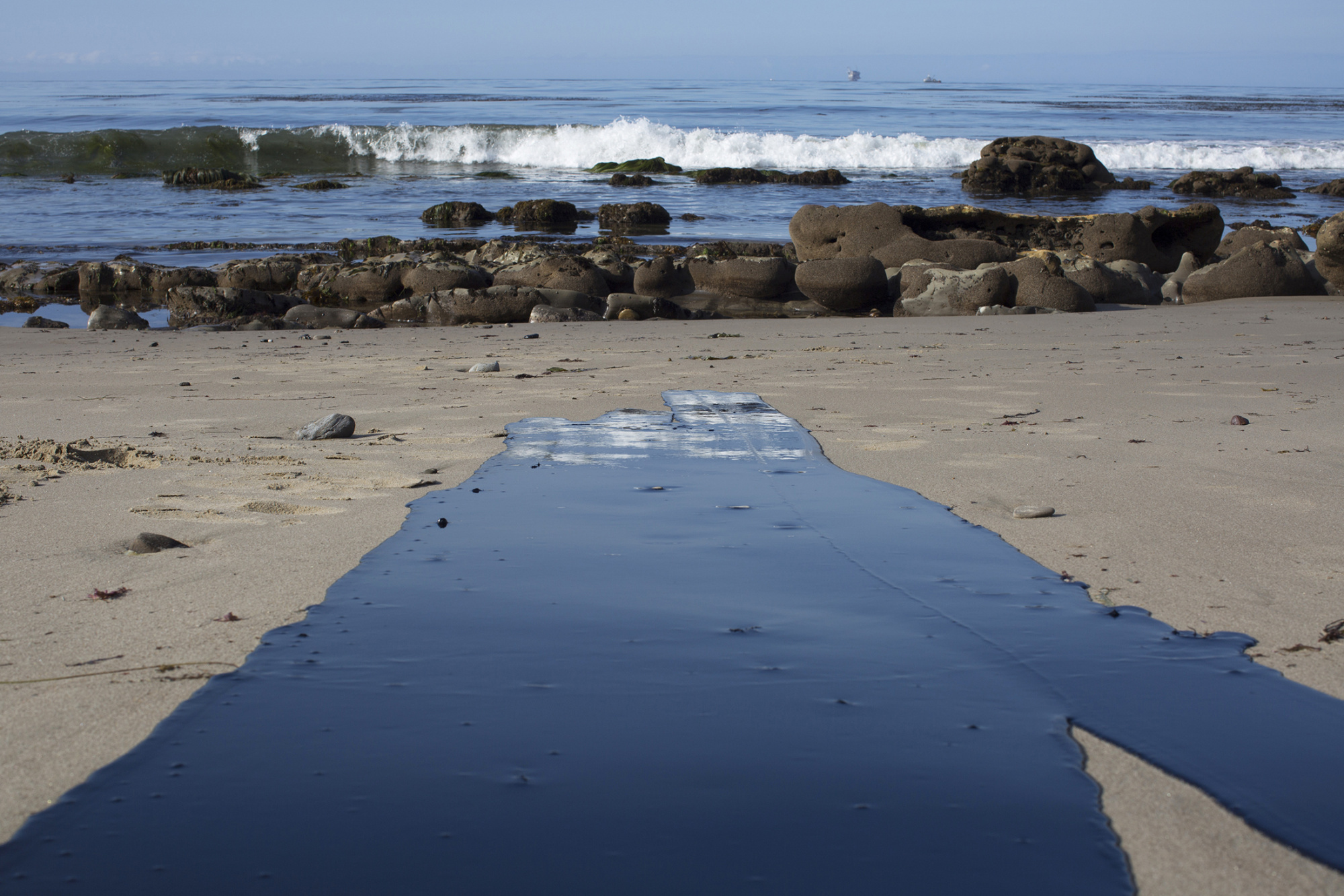 Oil flows toward the ocean from an inland oil spill near Refugio State Beach in California.
