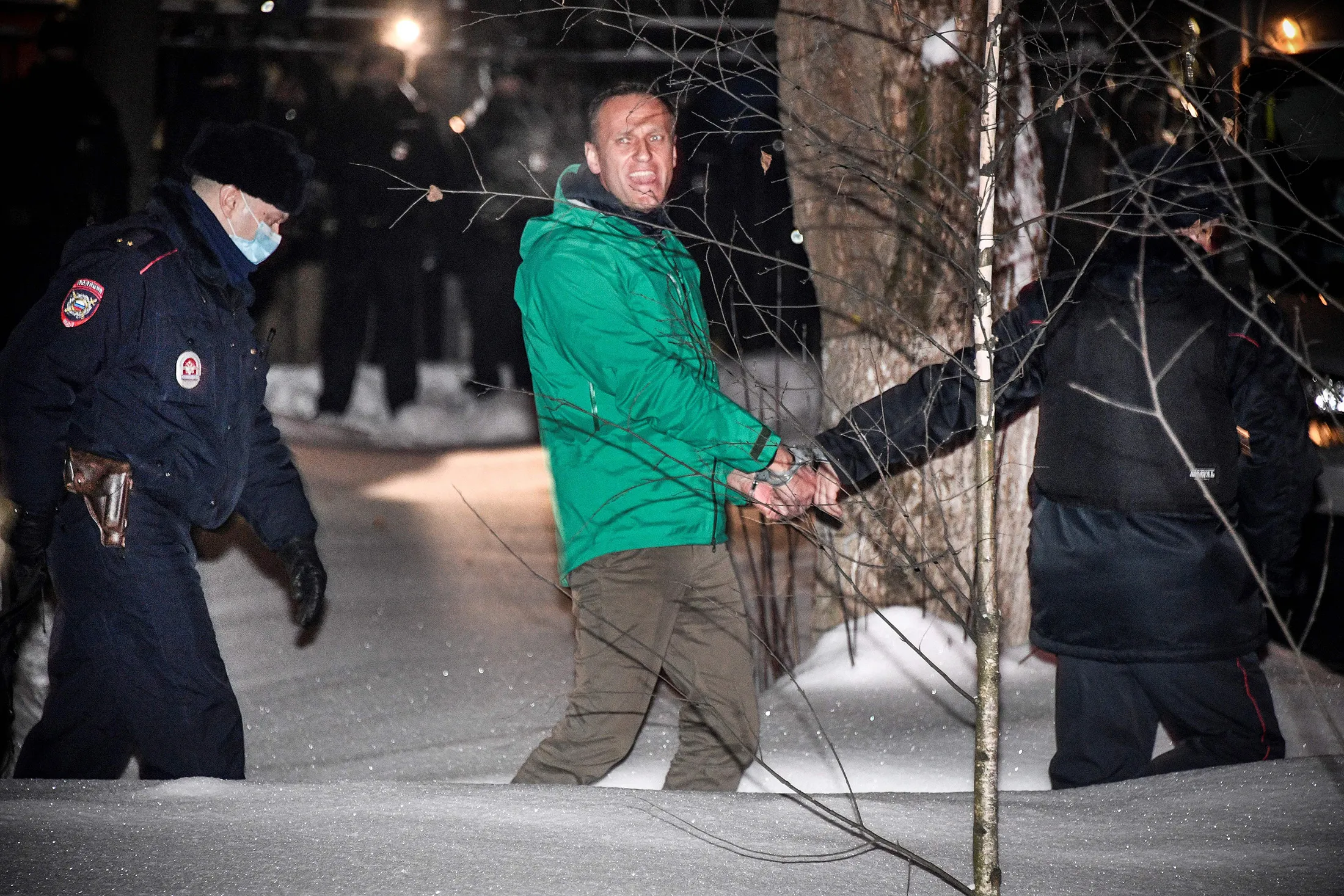 Alexey Navalny is escorted from a police station in Khimki, Russia, on Jan. 18.