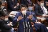 TOPSHOT - Japan's Prime Minister Shinzo Abe, wearing a face mask amid concerns over the spread of COVID-19 coronavirus, attends an upper house committee meeting at the parliament in Tokyo on April 1, 2020. (Photo by STR / JIJI PRESS / AFP) / Japan OUT (Photo by STR/JIJI PRESS/AFP via Getty Images)