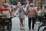A mother and daughter stroll in Shanghai as a Chinese law requiring people to visit elderly relatives takes effect