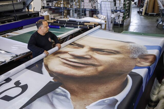A worker rolls up a newly printed political campaign poster for Benjamin Netanyahu, Israel's prime minister and leader of Likud, at a printing house in Rosh Haayin, Israel, on Wednesday, March 10, 2021. Israel is headed for its fourth vote in two years with Prime Minister Benjamin Netanyahu running against a crop of challengers who say it’s time for the indicted leader to go.