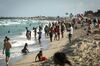 People gather on a beach in the South Beach neighborhood of Miami, on March 27.