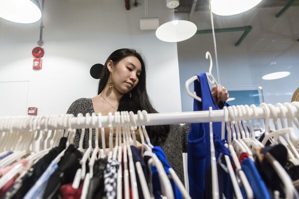 An employee sorts clothing. Image: Ore Huiying/Bloomberg