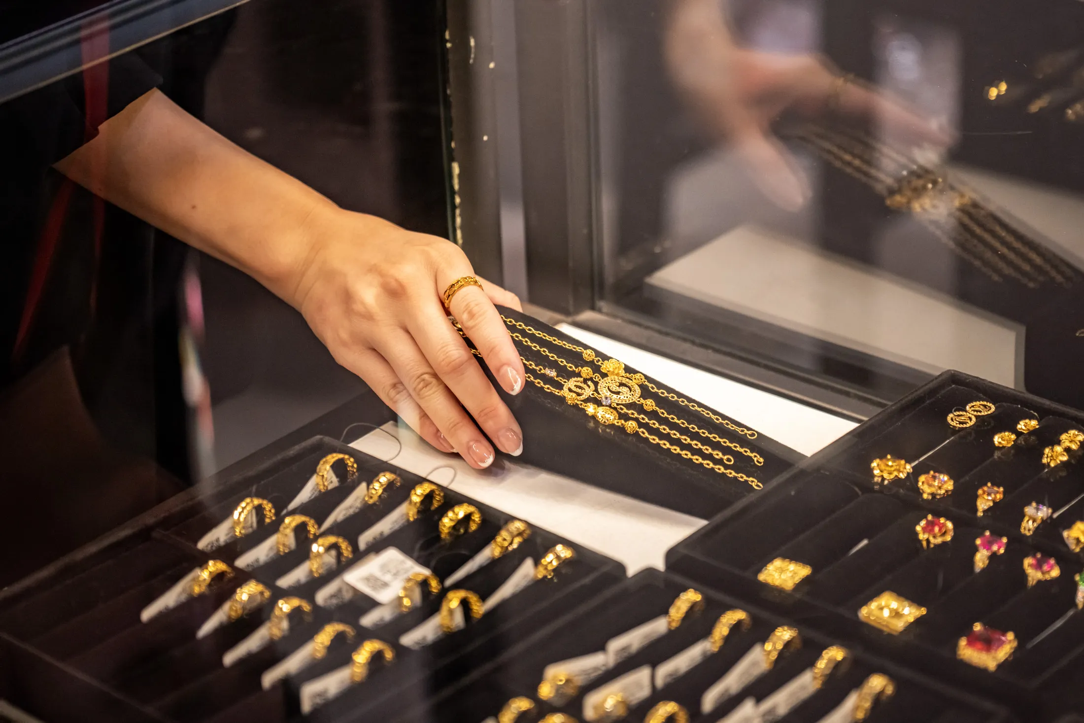 An employee handles gold bracelets inside a jewelry shop in Hanoi, Vietnam, on Feb.&nbsp;19, 2024.&nbsp;