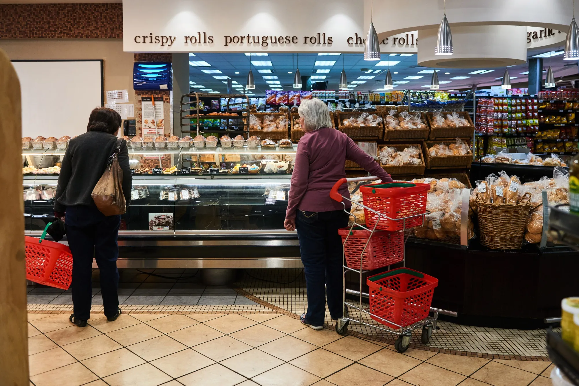 Customers at the bakery counter inside a Spar Group Ltd. supermarket in the Die Wilgers suburb of Pretoria, South Africa.