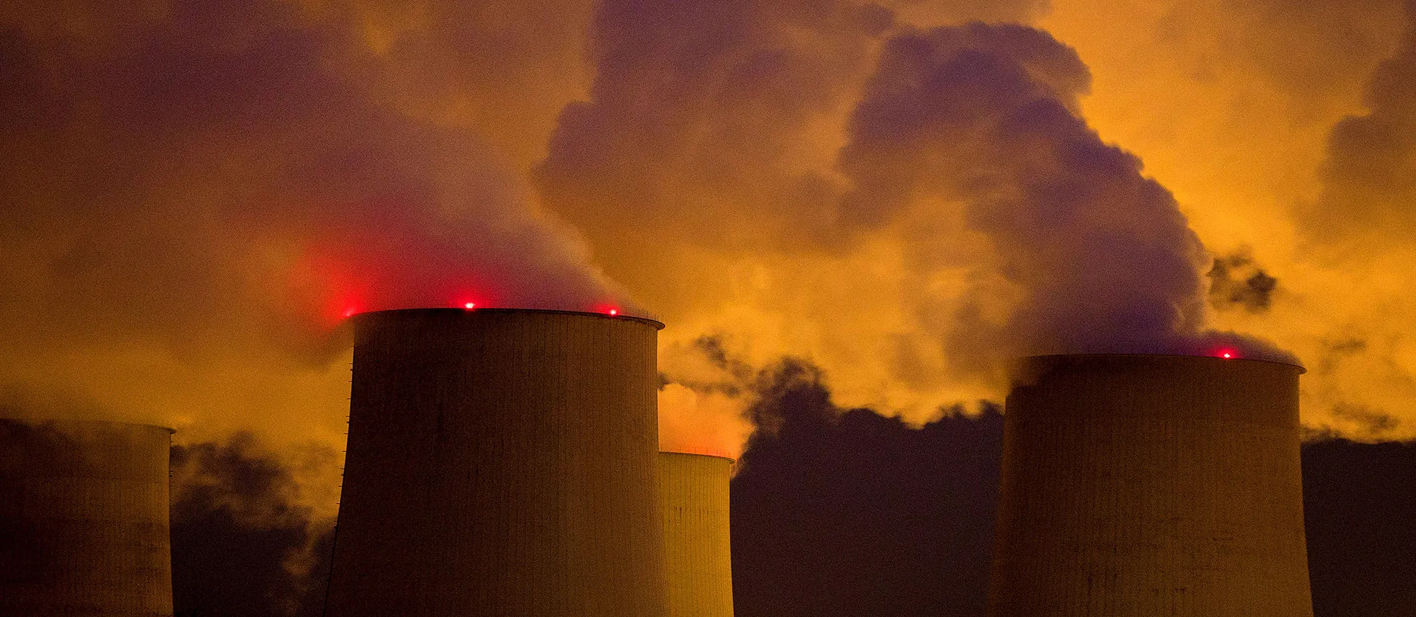 Emissions rise from cooling towers at a lignite fired power plant&nbsp;in Peitz, Germany.