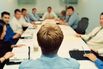 Business executives in conference, man in foreground