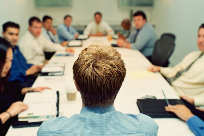 Business executives in conference, man in foreground