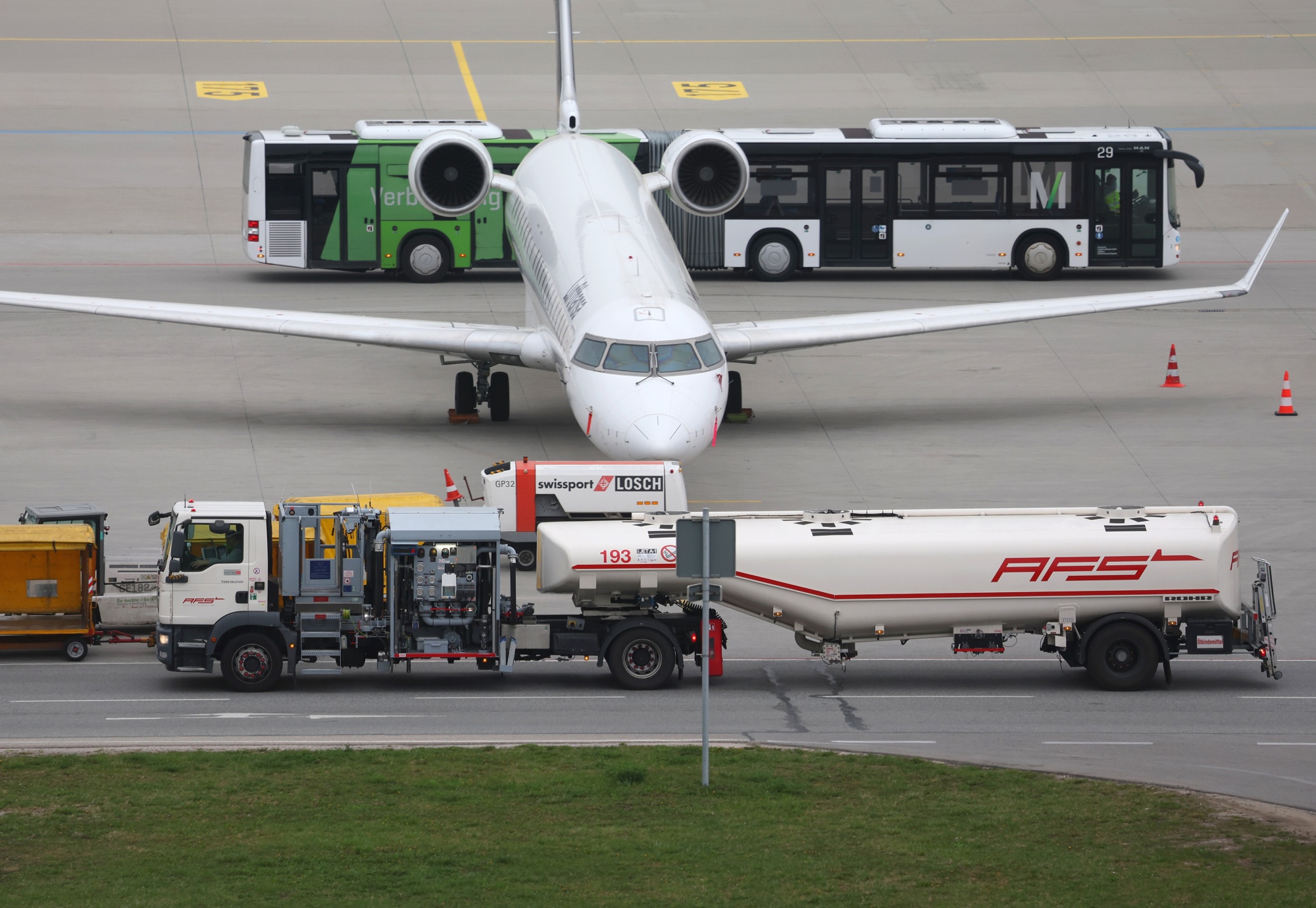 A refueling vehicle passes a passenger aircraft at Munich Airport, on April 14. 