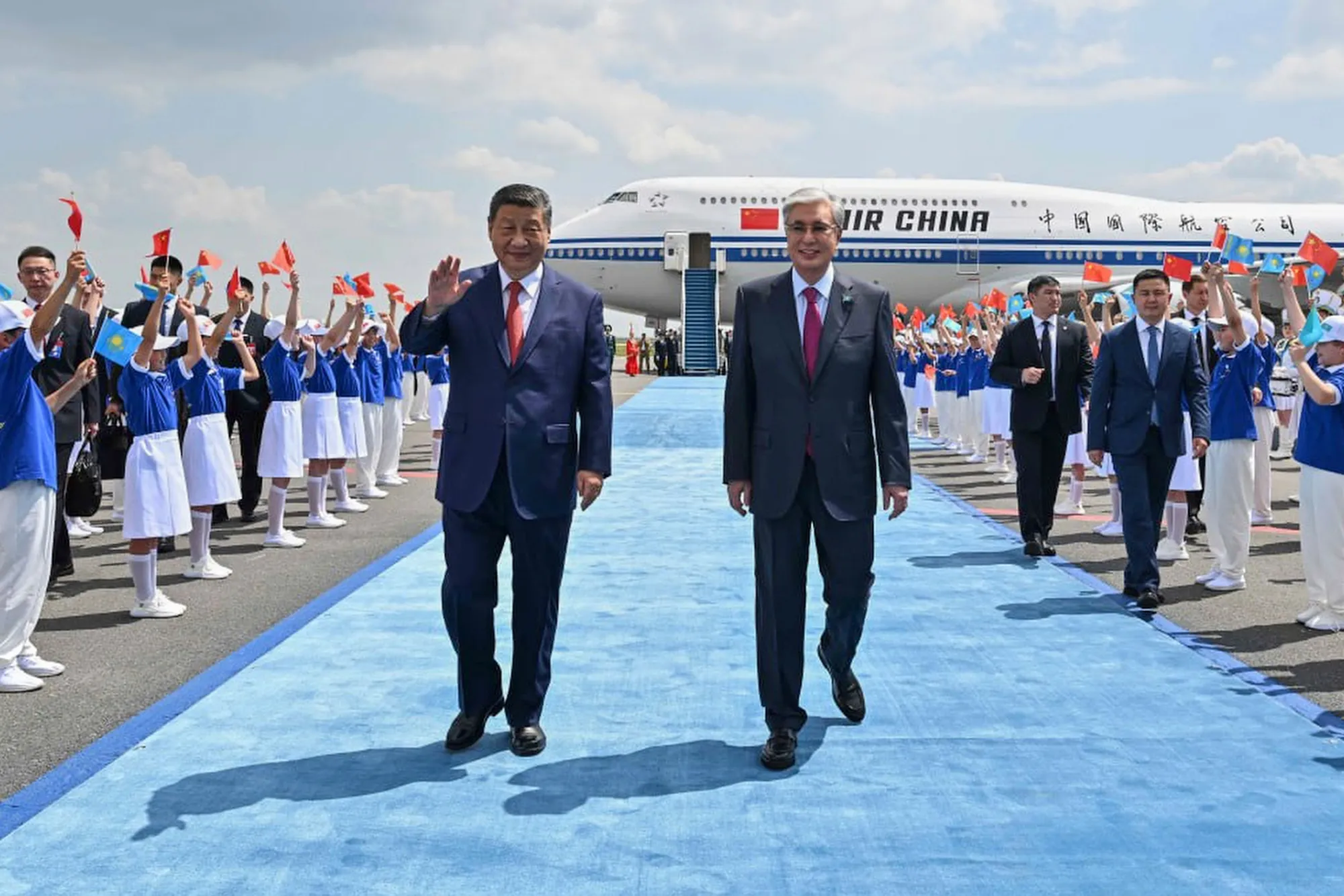 Chinese leader Xi Jinping, left, walks with Kazakh President Kassym-Jomart Tokayev near Astana in June 2025.