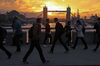 Commuters walk across London Bridge against a backdrop of Tower Bridge during sunrise in London, U.K., on Friday, Oct. 21, 2016.