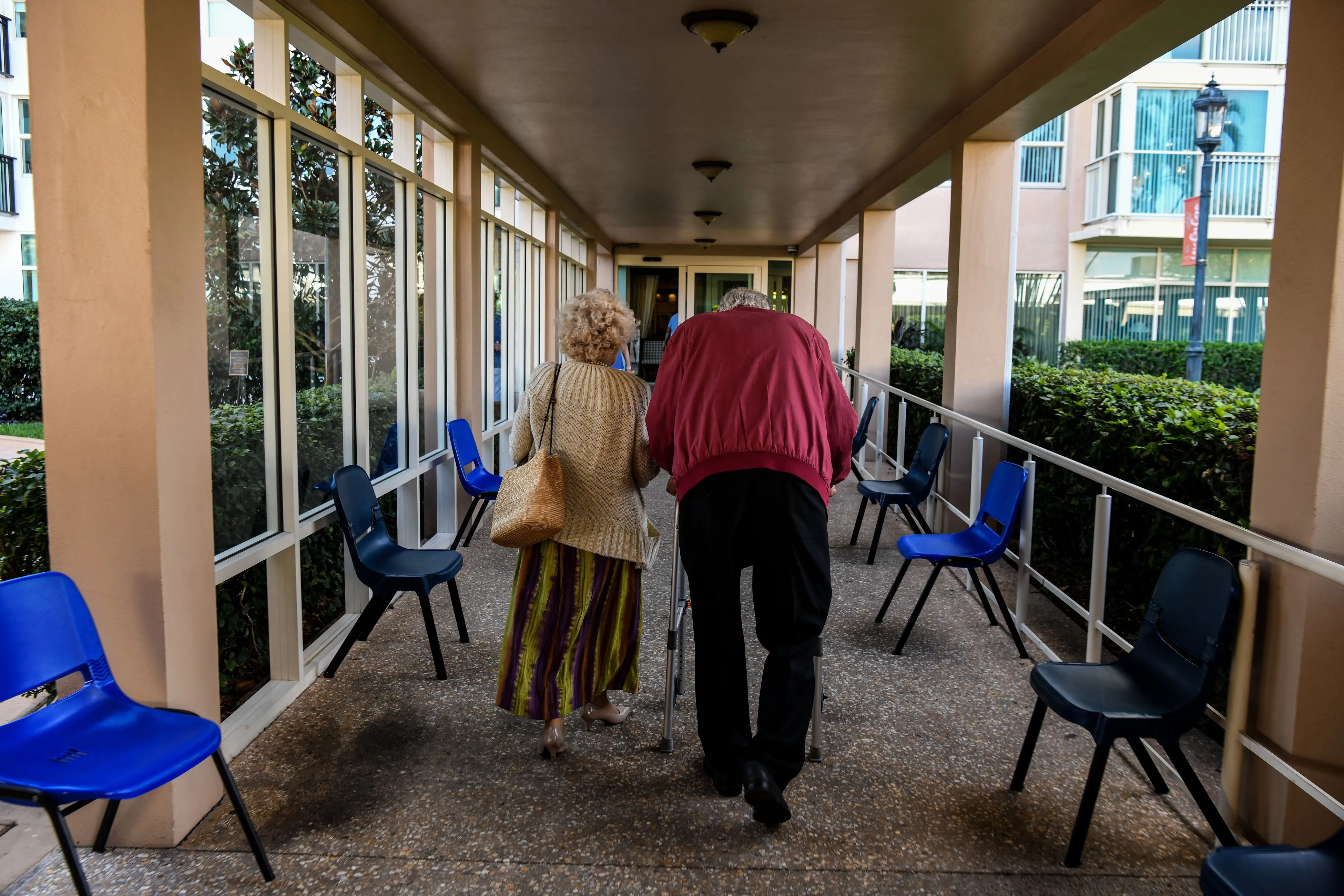 An elderly residents walk&nbsp;inside a retirement community.