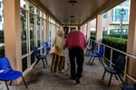 An elderly residents walk inside a retirement community.
