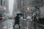 A pedestrian crosses a street during a snow storm in New York, U.S., on Friday, Jan. 7, 2022.