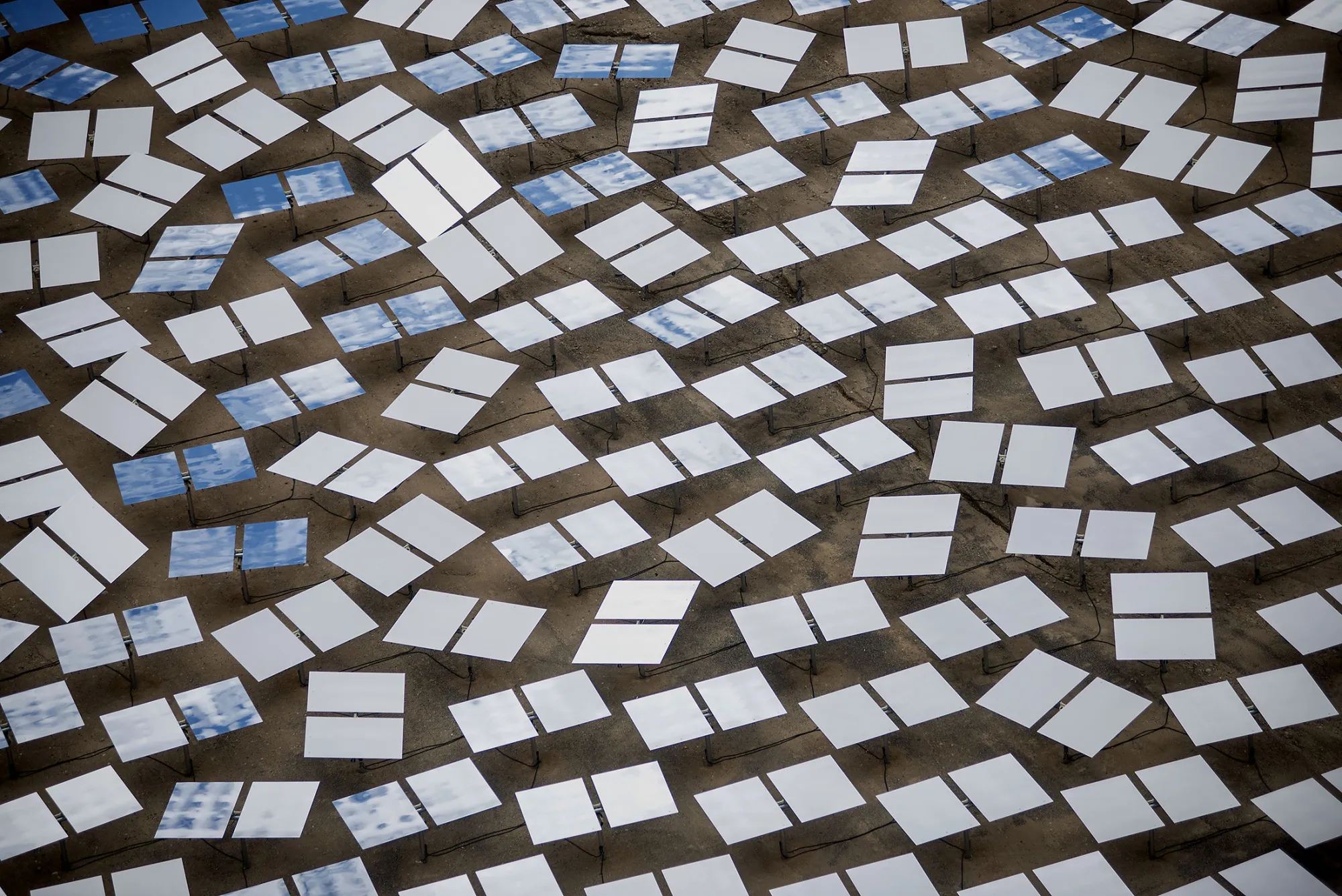 Solar panels stand at the Ivanpah Solar Electric Generating System in the Mojave Desert near Primm, Nevada, U.S., on Monday, March 10, 2014. The 392-megawatt California Ivanpah plant developed by Google, NRG and Bright Source, which began operating in February, brings utility-scale solar to more than 5.5 gigawatts, up 1,089% since 2010.
