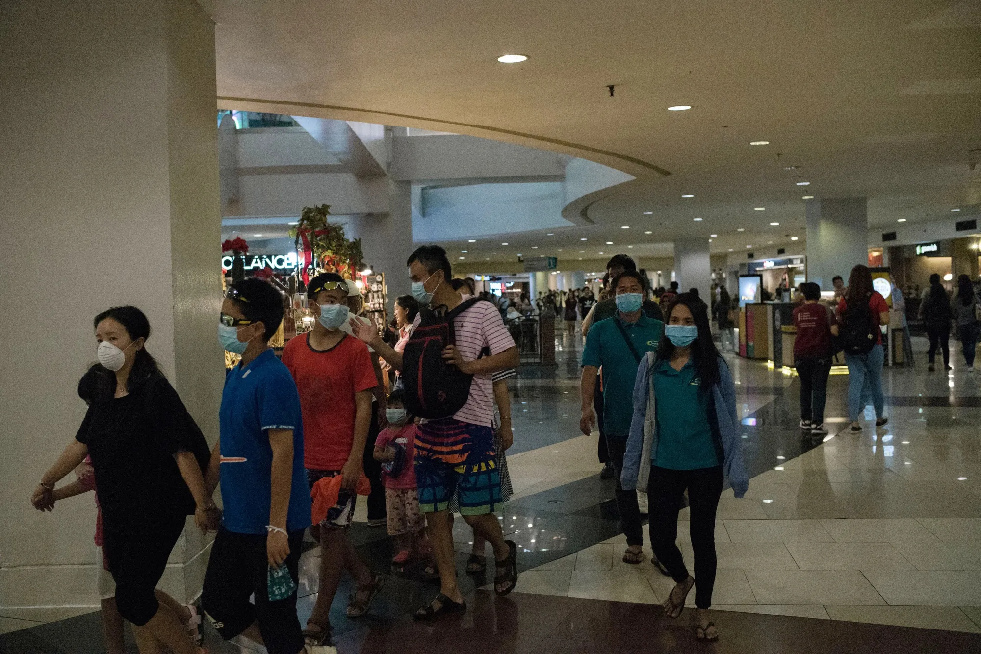 Shoppers wear face masks inside a mall in Manila on Feb. 3.