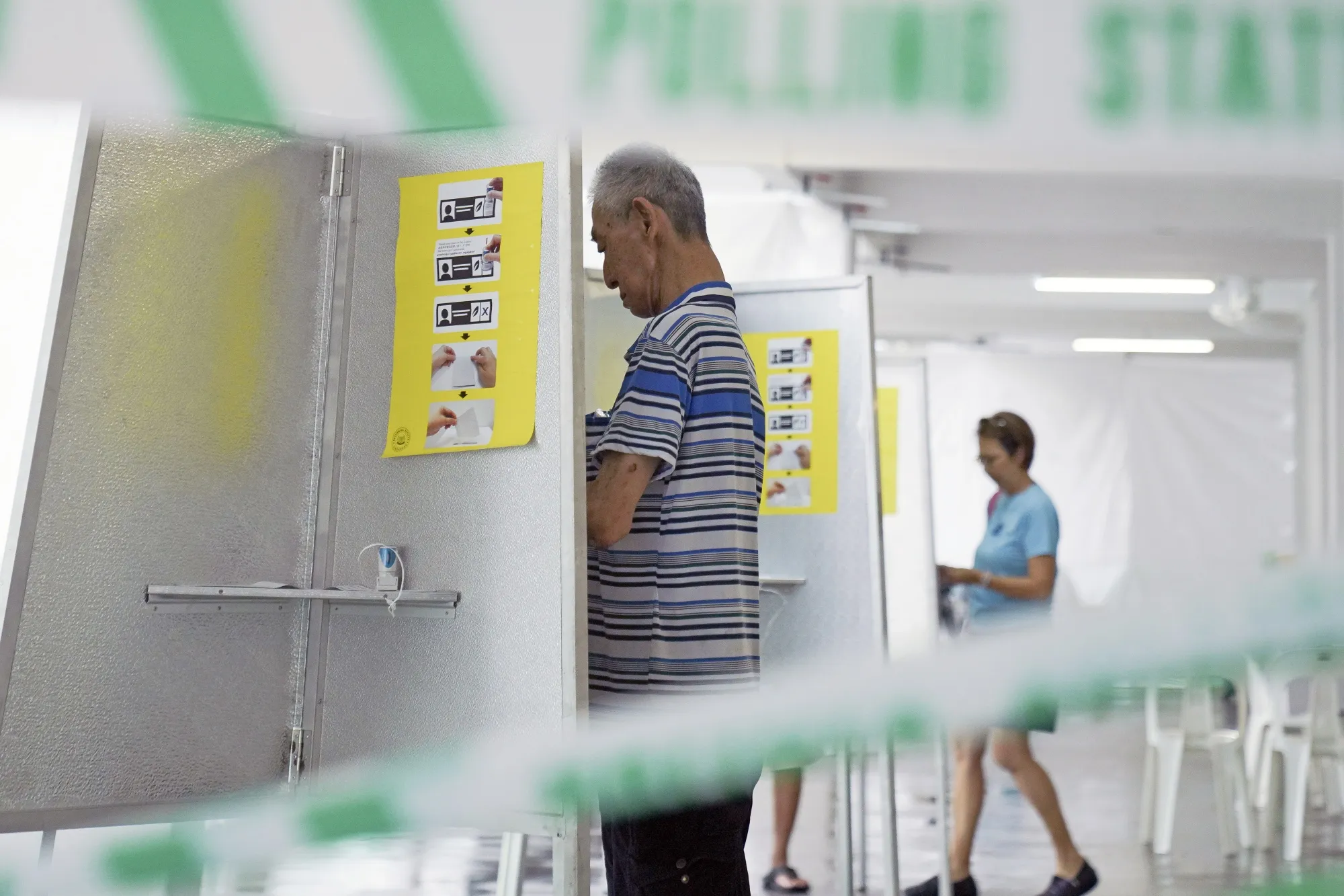 A voter fills a ballot paper at a polling station in Singapore on May 3.