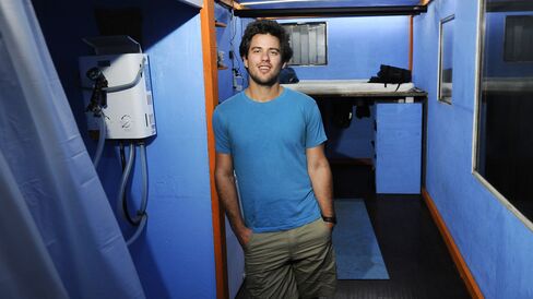Luke Iseman inside his converted shipping container home. Photographer: Michael Short/Bloomberg