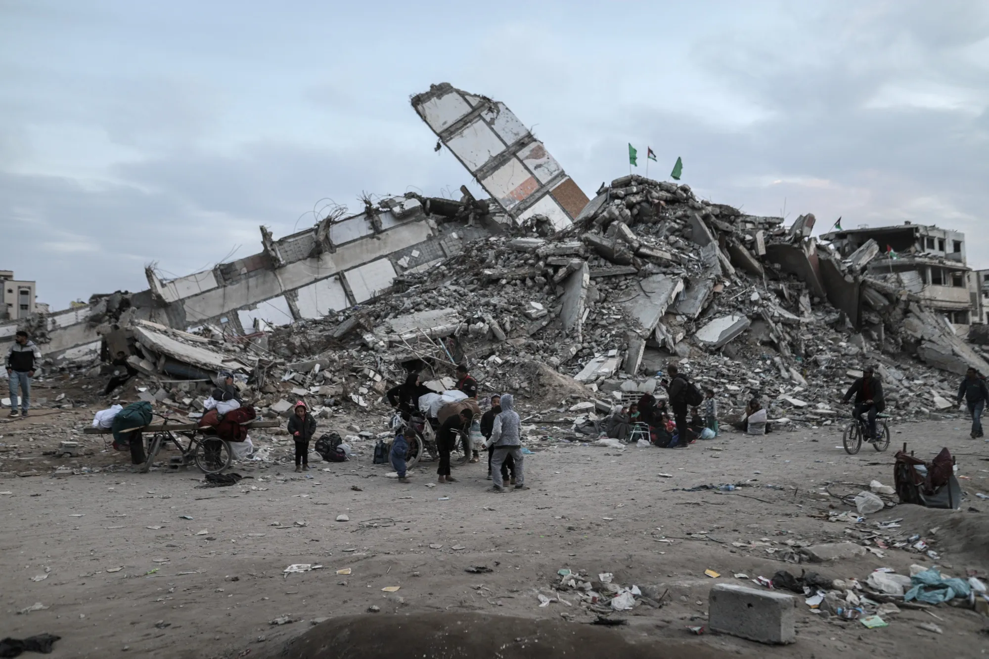 Displaced Palestinians pass destroyed buildings as they return to the northern Gaza Strip on Jan. 28.