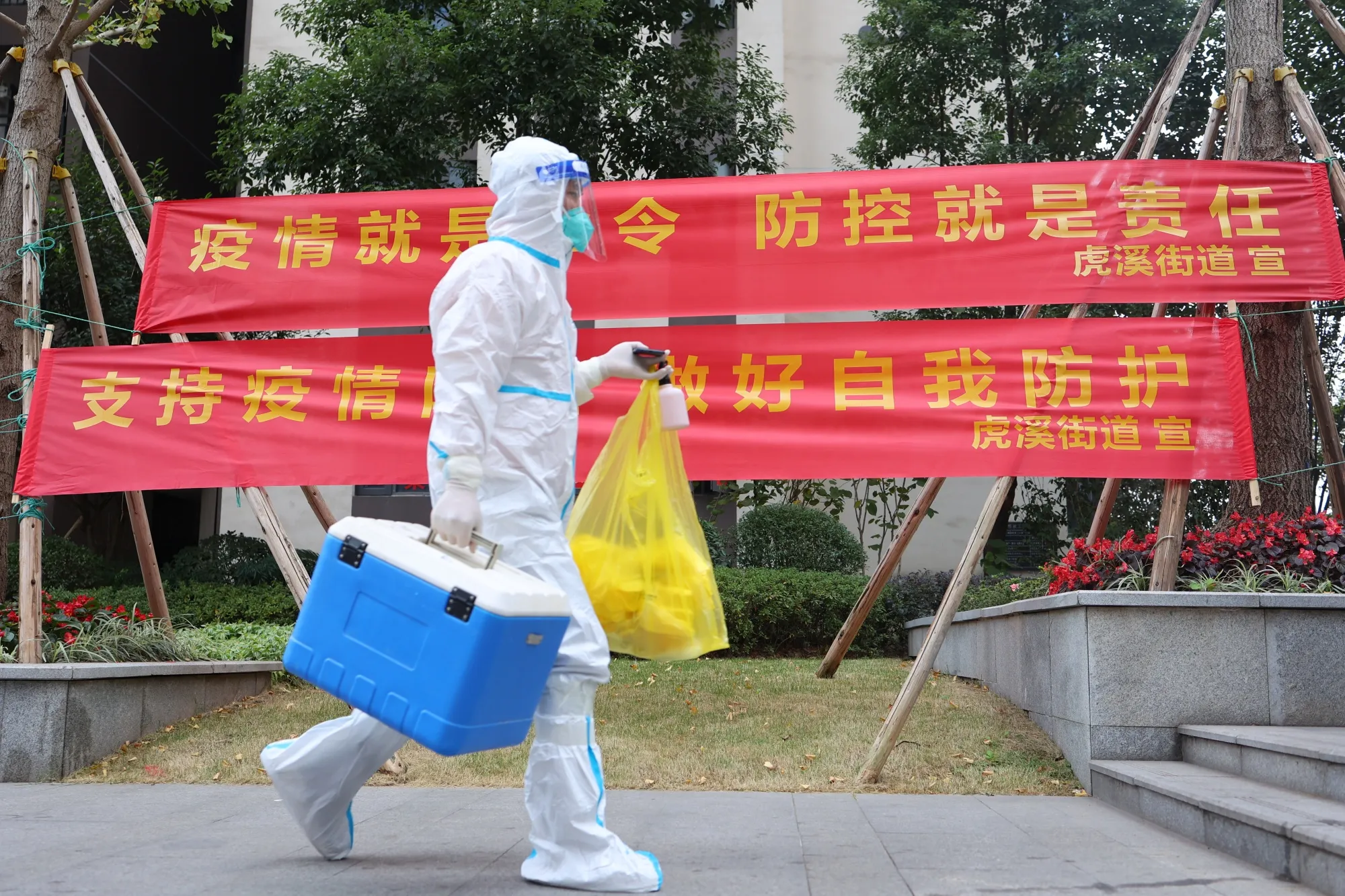 A worker transfers swab samples from residents in Chongqing, on Nov. 17. 