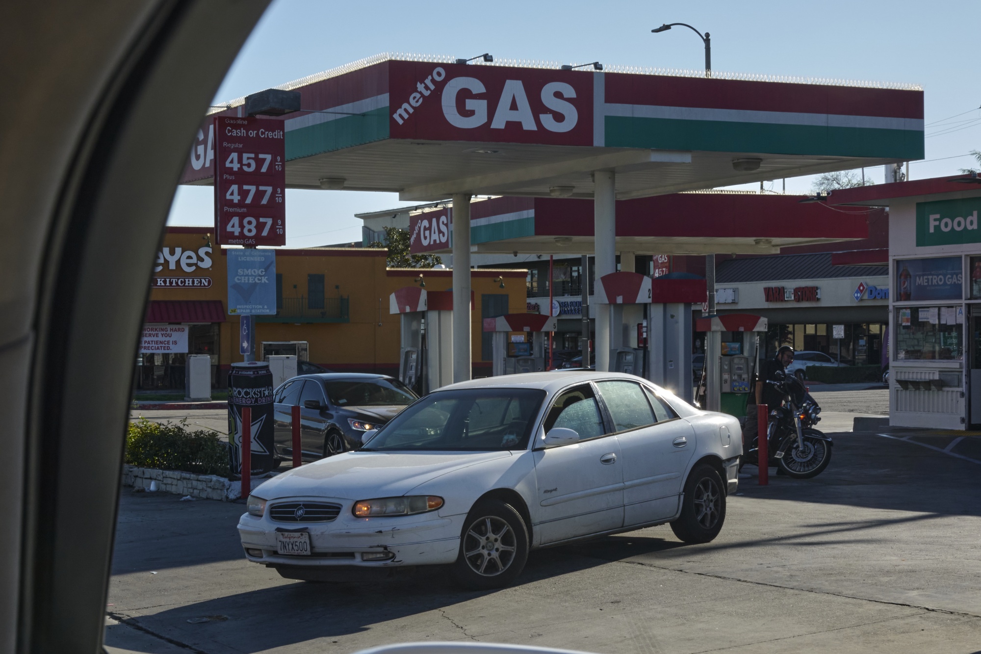 A car leaves a gas station in Los Angeles.