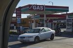 A car leaves a gas station in Los Angeles.