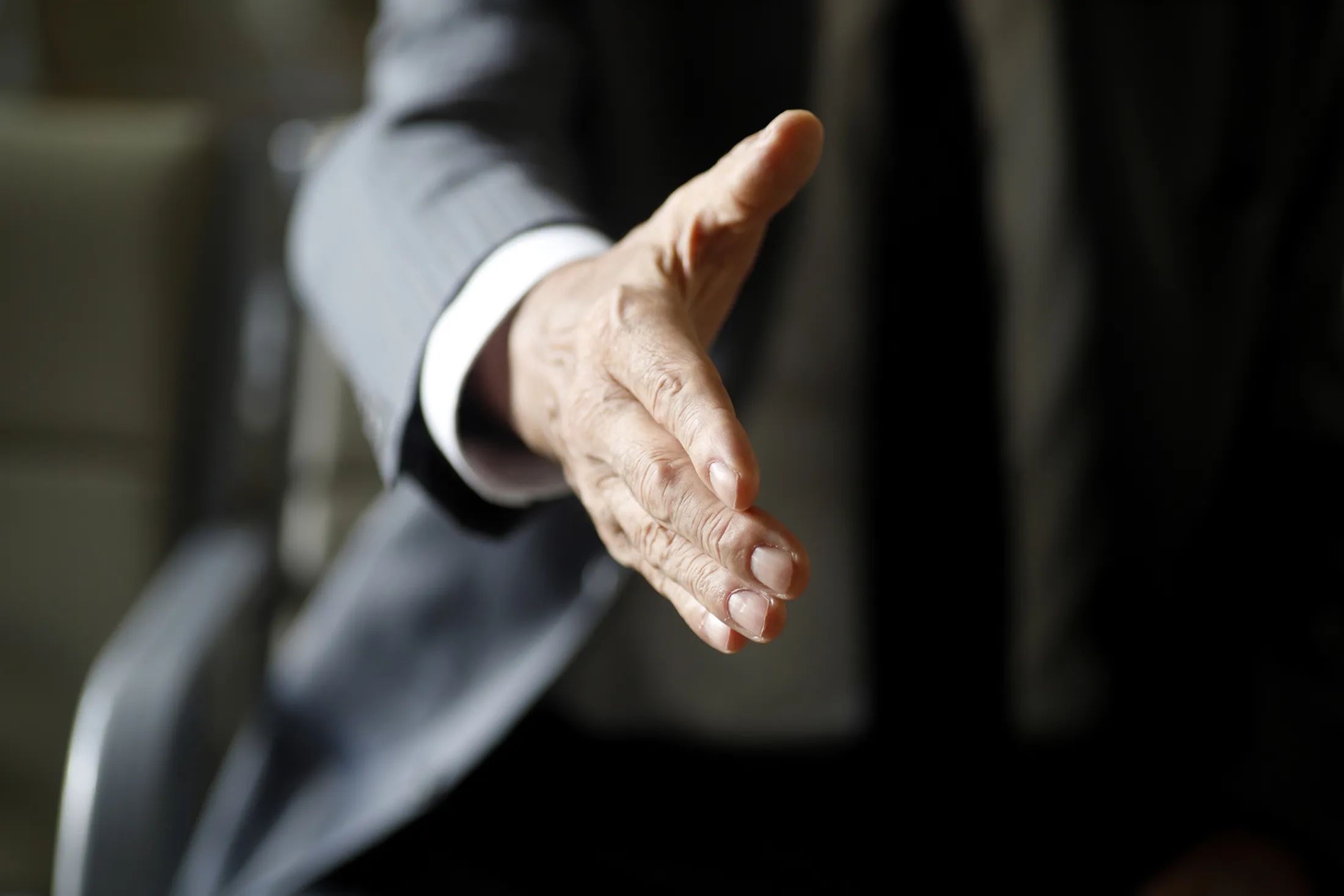 Senior businessman offering handshake