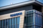 Regeneron Pharmaceuticals Inc. signage is displayed outside their headquarters in Tarrytown, N.Y., U.S., on June 12, 2020. Regeneron Pharmaceuticals Inc. said it had begun human trials of a new antibody cocktail for Covid-19, part of an ambitious clinical-testing plan that could lead to a new treatment option by the end of summer if all goes well.