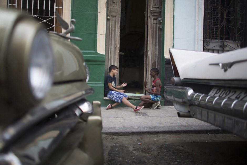 Two youths play futbolito in downtown Havana.