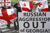 Georgians protest outside the Russian em