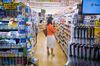 A woman holds a package of medicine inside a Cocokara Fine Inc. store in Tokyo.