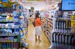 A woman holds a package of medicine inside a Cocokara Fine Inc. store in Tokyo.