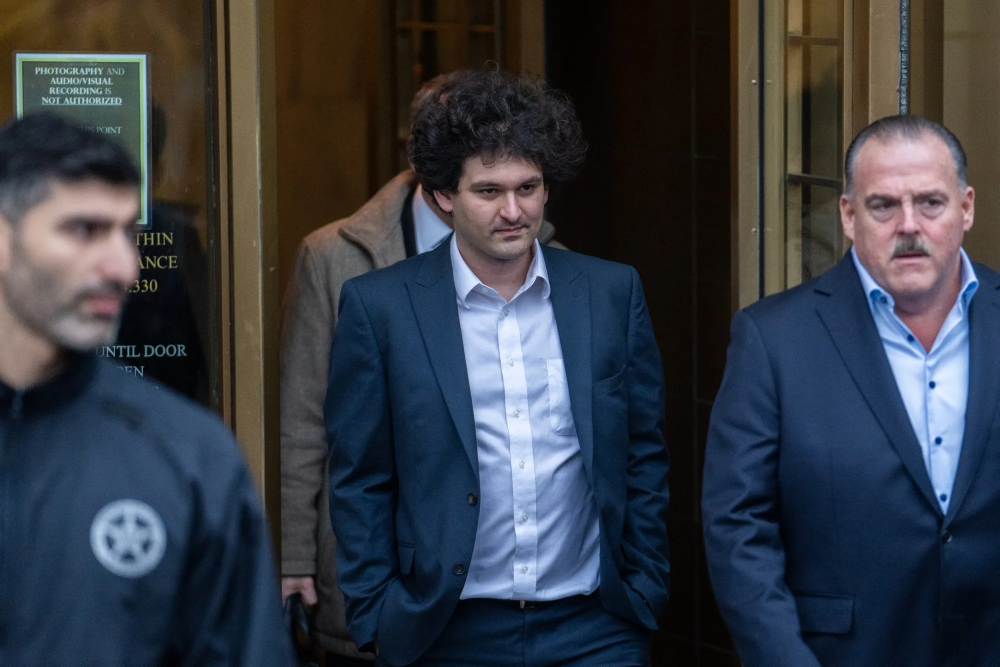 Sam Bankman-Fried, center, departs court in New York, on Jan. 3. 