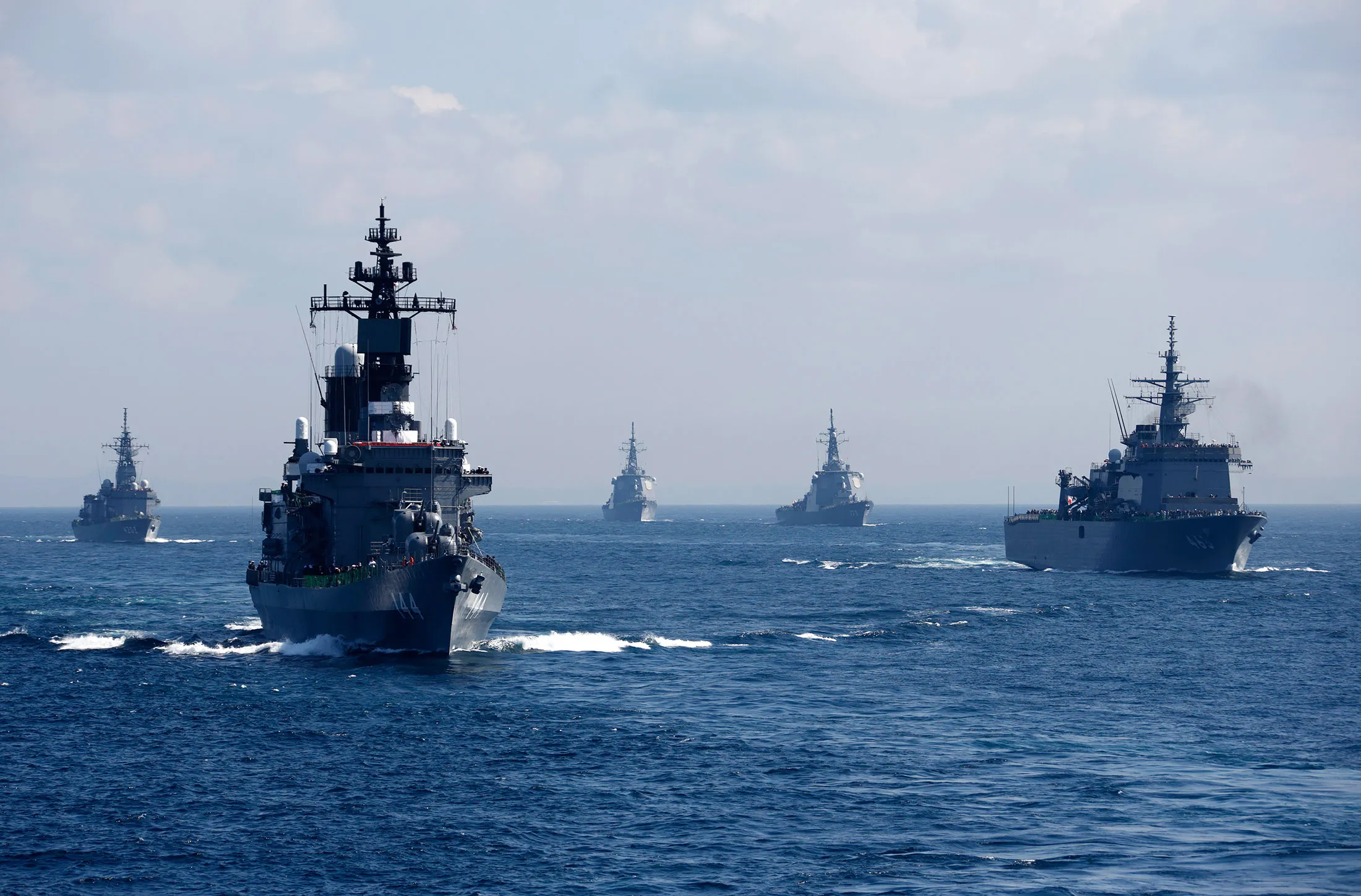 Japan's Maritime Self-Defense Force destroyer ship Kurama, left, leads a troop of vessels during a review at Sagami Bay, Japan, on Oct. 18, 2015.
