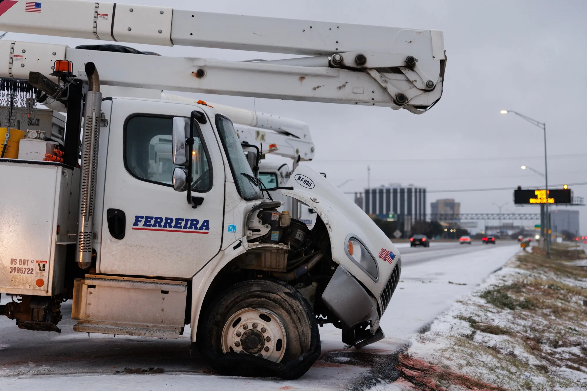 A utility truck that slid off Highway 183 during a winter storm in Dallas on Jan. 24.