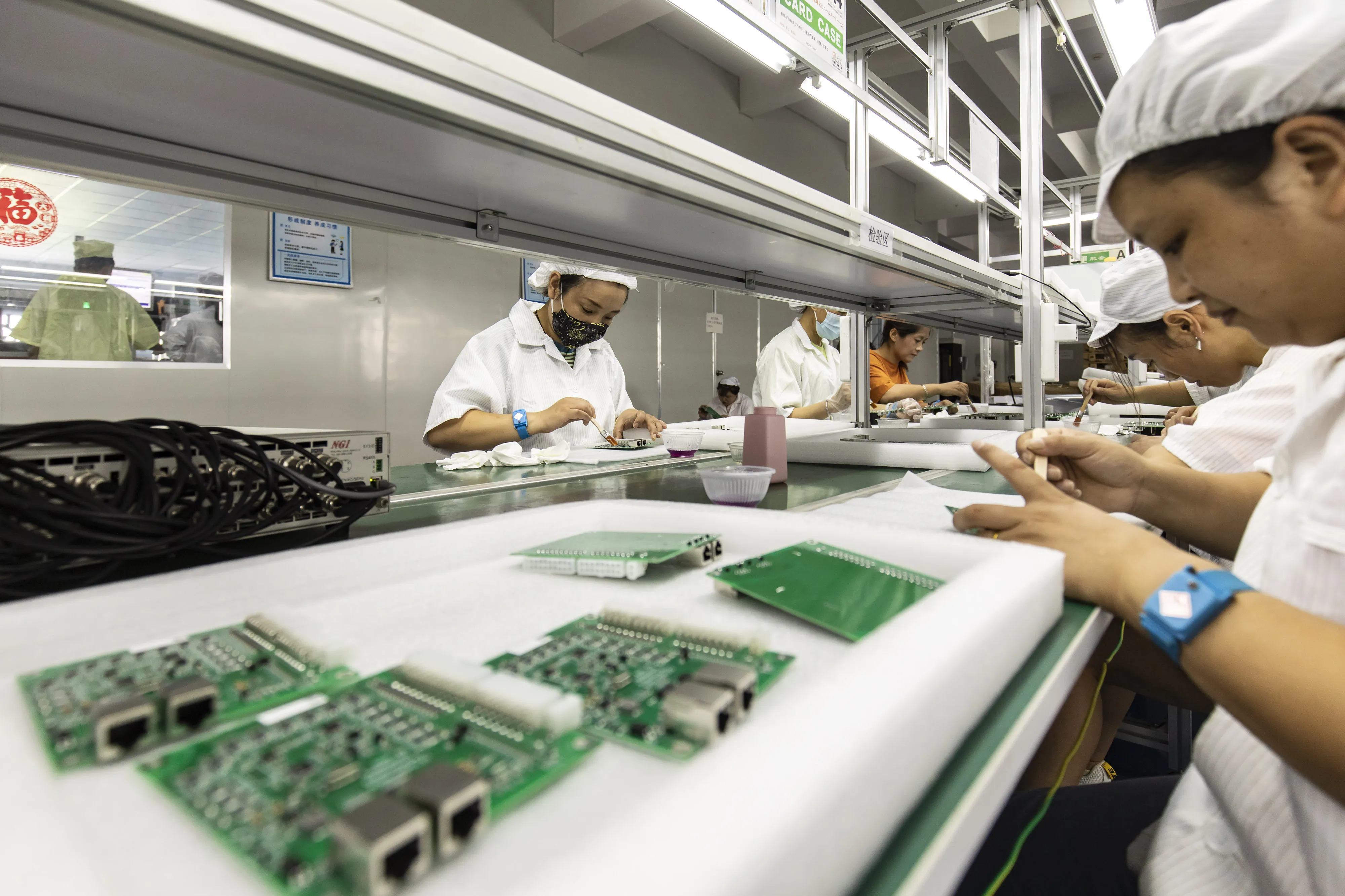 Employees on a&nbsp;production line at a Smart Pioneer Electronics Co. factory in Suzhou, China.