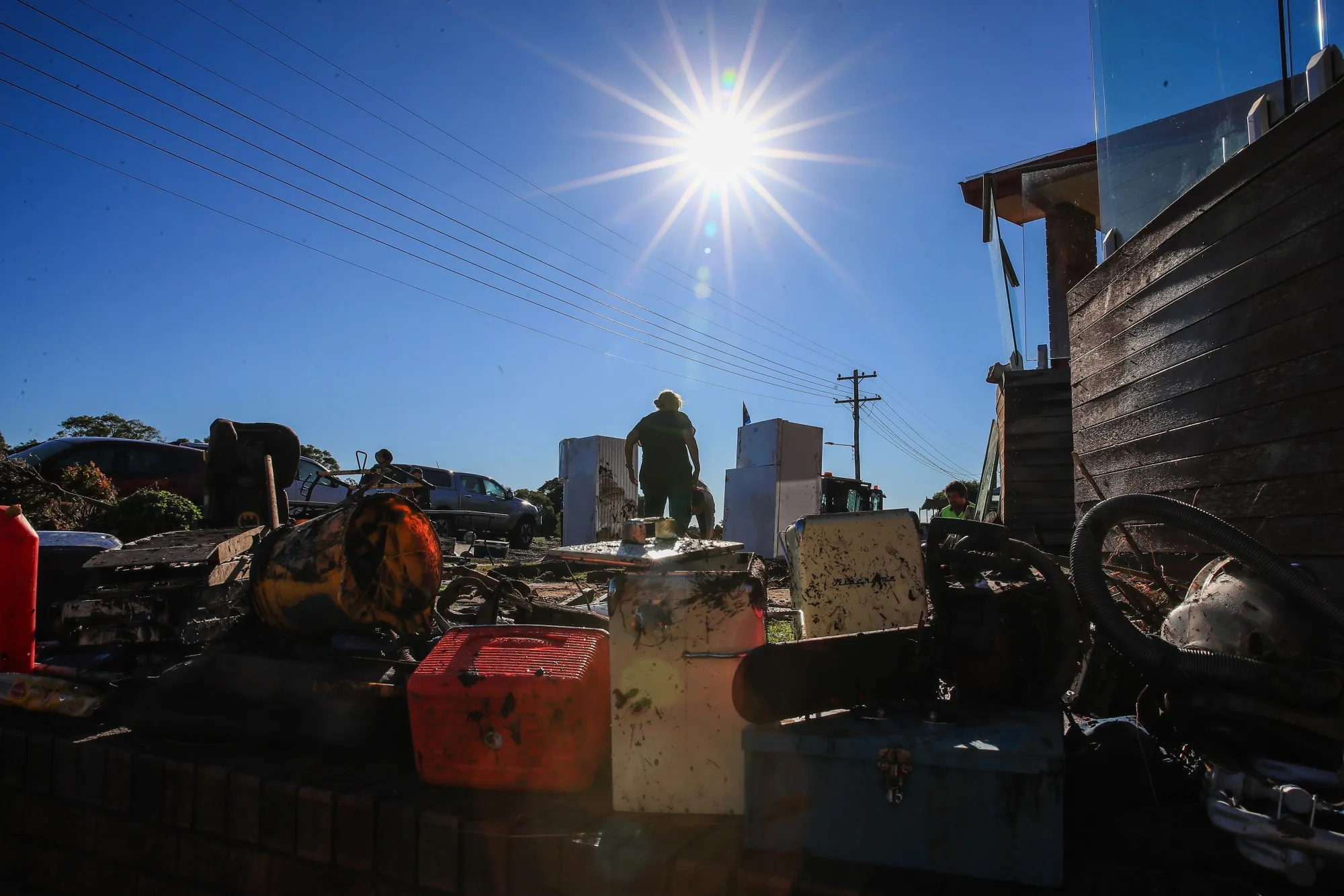 Residents clean a flood-damaged house in Taree on May 24.