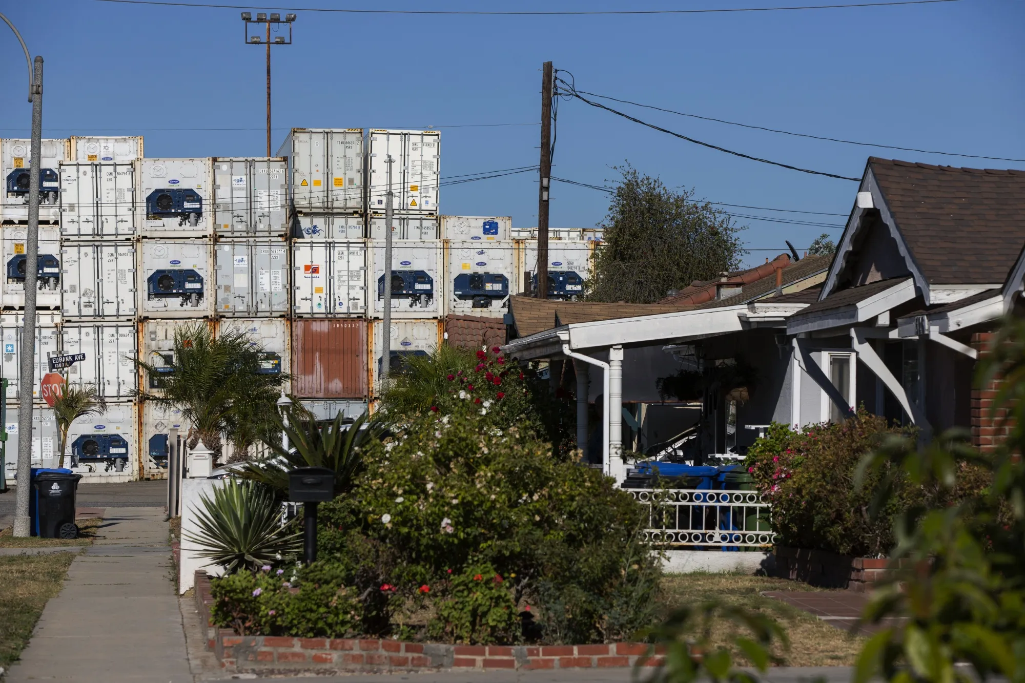 Shipping containers are stacked across the street from a residential area in the Wilmington neighborhood of Los Angeles on&nbsp;July 12.