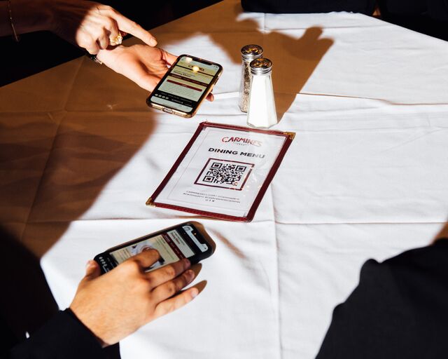 The menus are found through QR codes during a staff training session at Carmine's Italian Restaurant - Times Square location