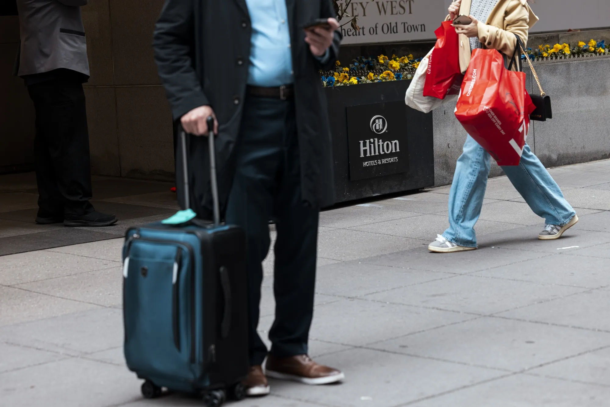 Pedestrians walk past a Hilton hotel in New York.