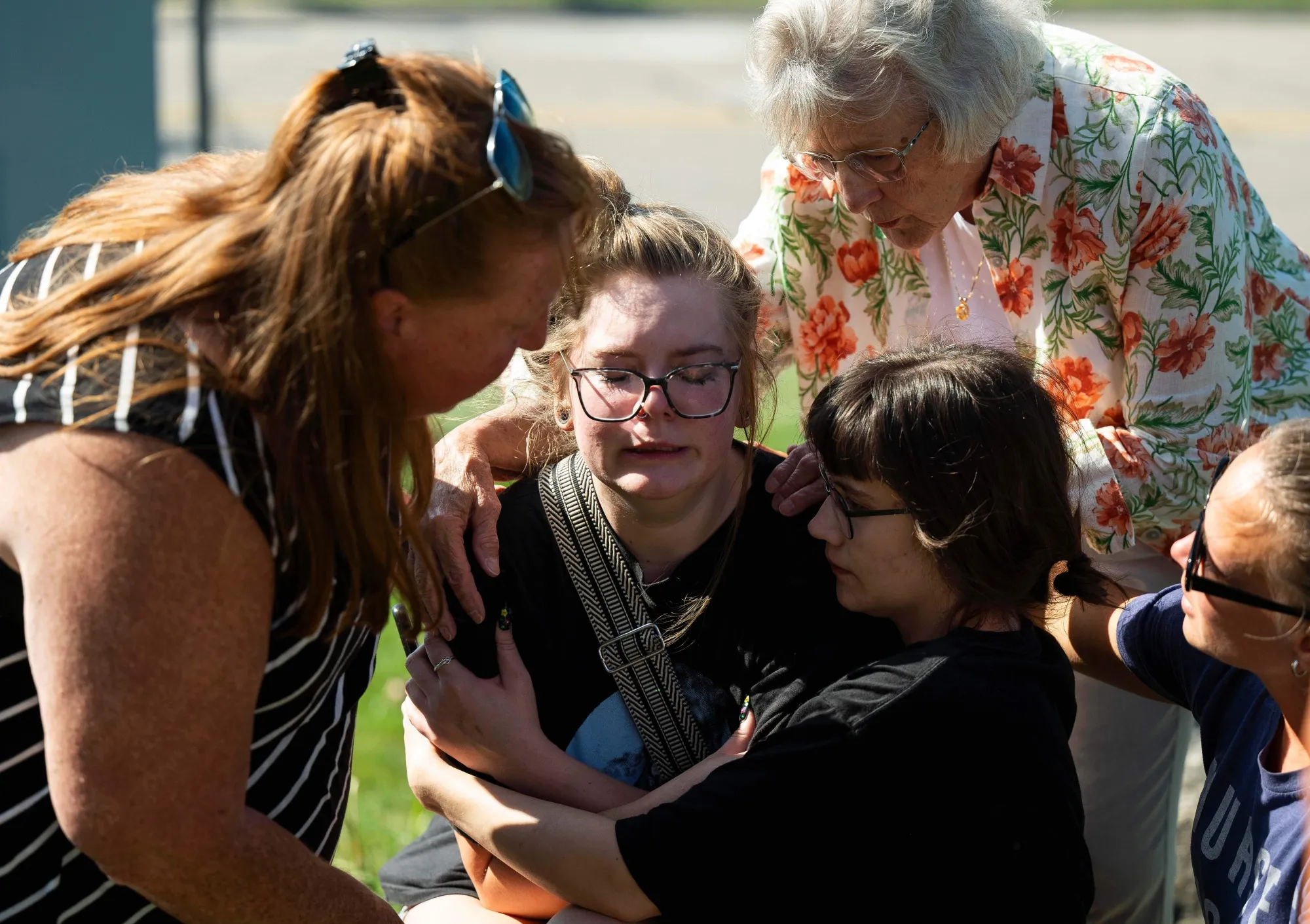 A woman is comforted at the scene of the shooting iin Michigan, on Sept. 28.