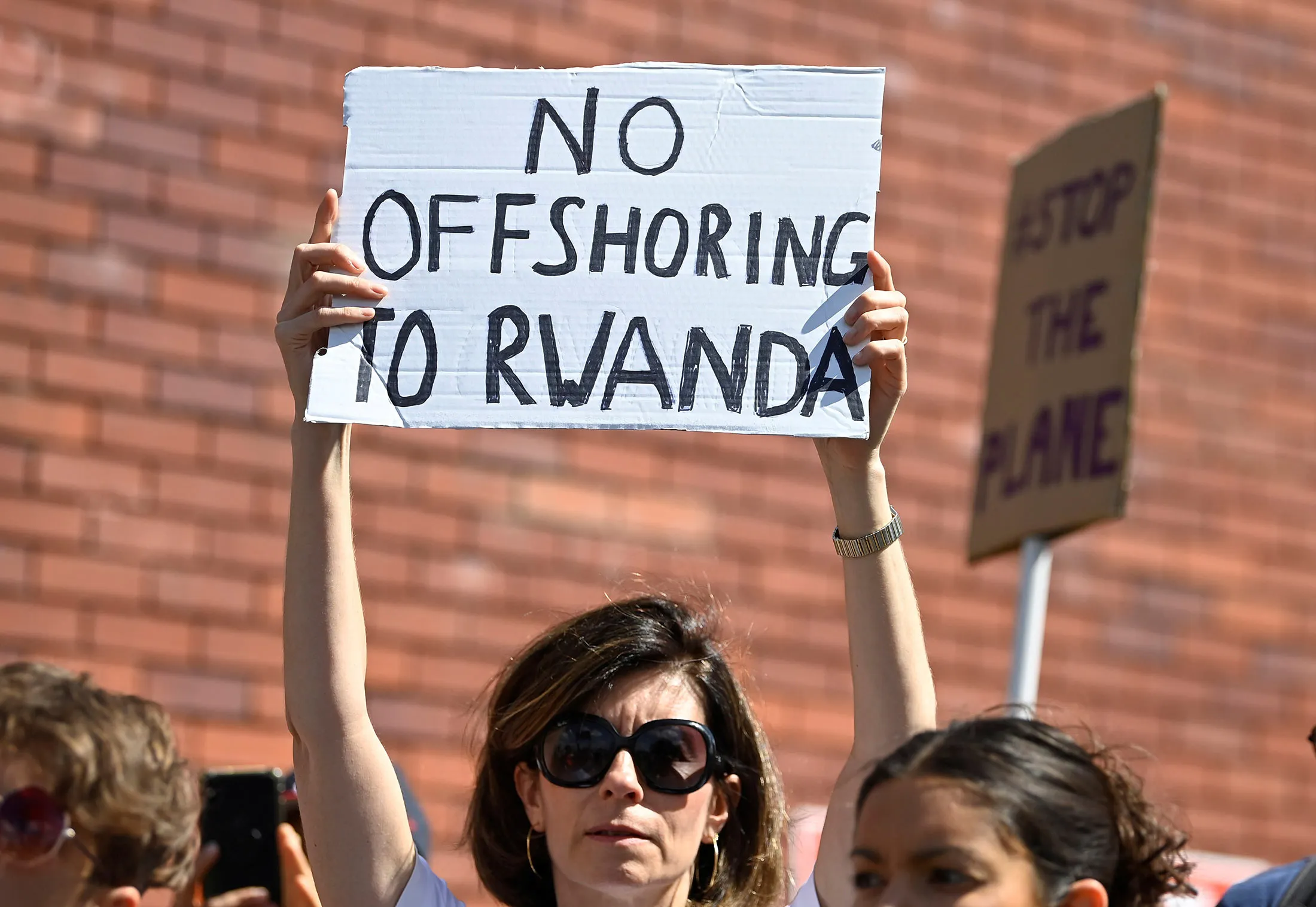 Demonstrators outside London Gatwick Airport protesting against a planned deportation of asylum-seekers from Britain to Rwanda in 2022.