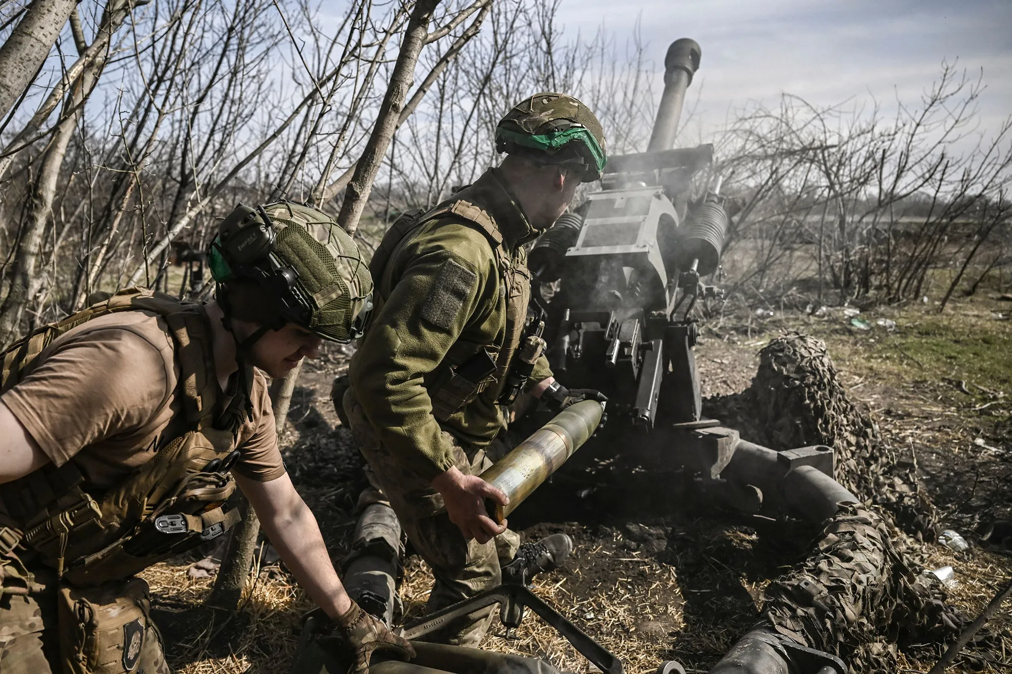 Ukrainian servicemen fire with an M119 105mm howtitzer at Russian positions near Bakhmut, on March 23.