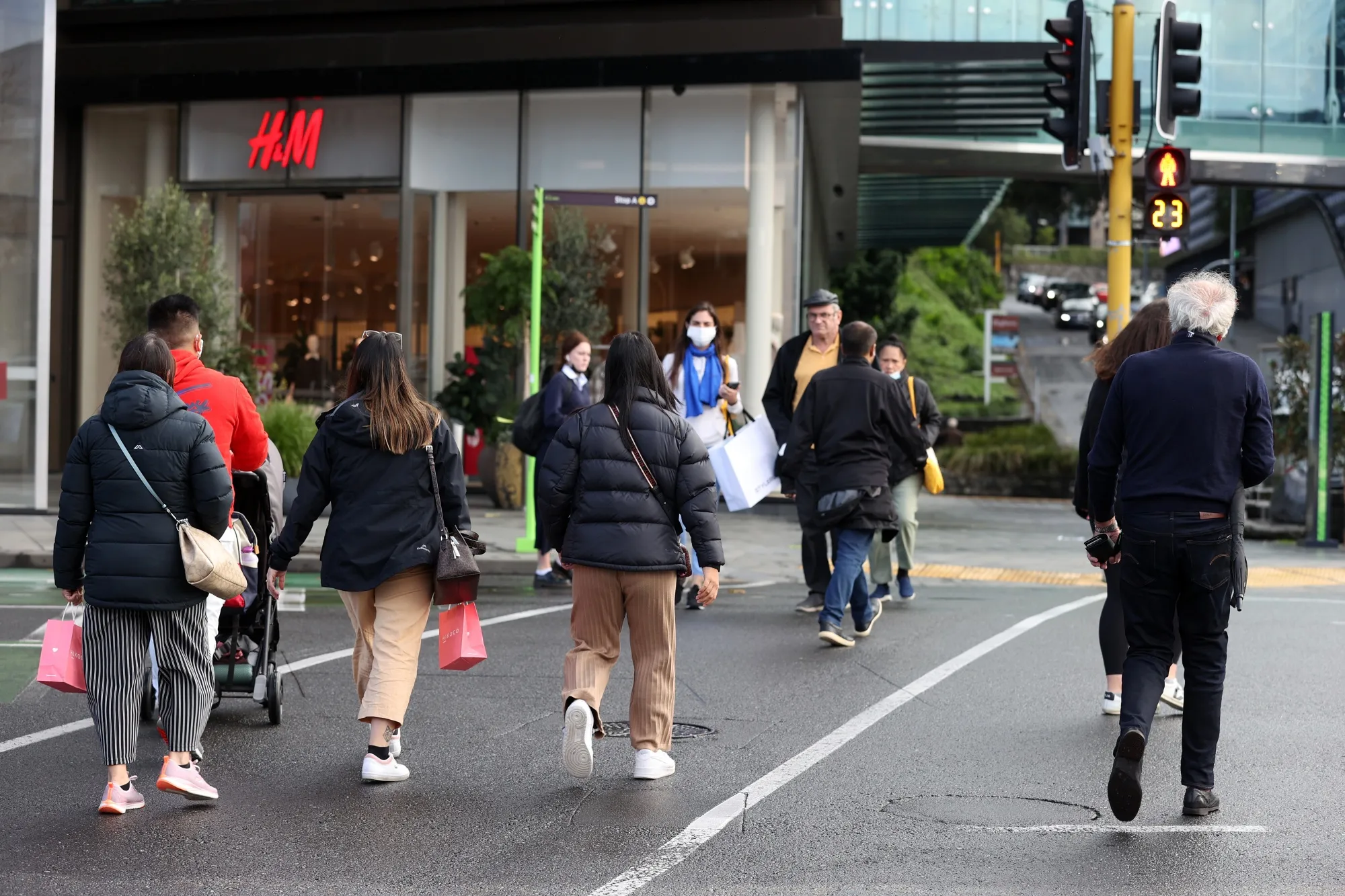Pedestrians cross a road in Auckland, New Zealand, on&nbsp;June 13.&nbsp;