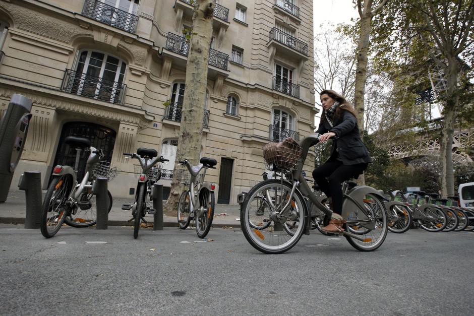 French student Alienor Saguez rides a Velib bike-sharing program in Paris.