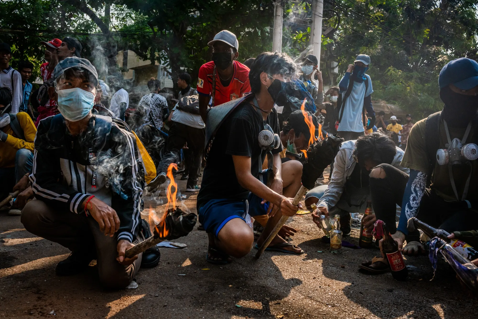 Protesters prepare Molotov cocktails.